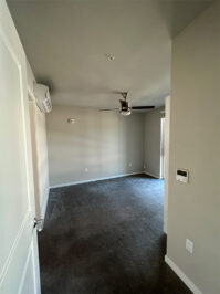 Apartment bedroom with carpet and large windows