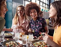 group of young women eating in a restaurant